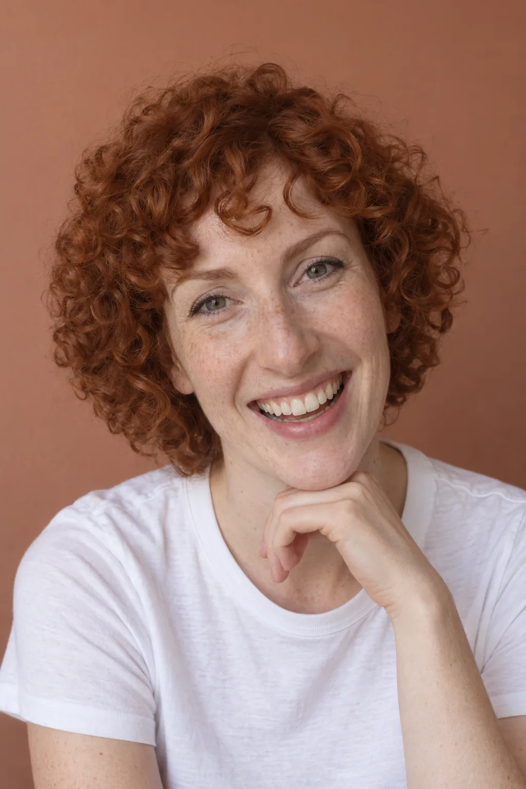 Model with copper curls and a bright smile